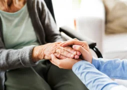 Hands gently holding elderly woman’s hand, symbolizing care, compassion, and senior support for the Call to Freedom GiveWP campaign.