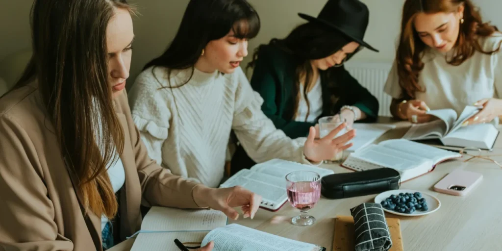 Group Bible study listening and reading Scripture together, representing Christian Bible teaching audio Denver and Freedom Street sessions