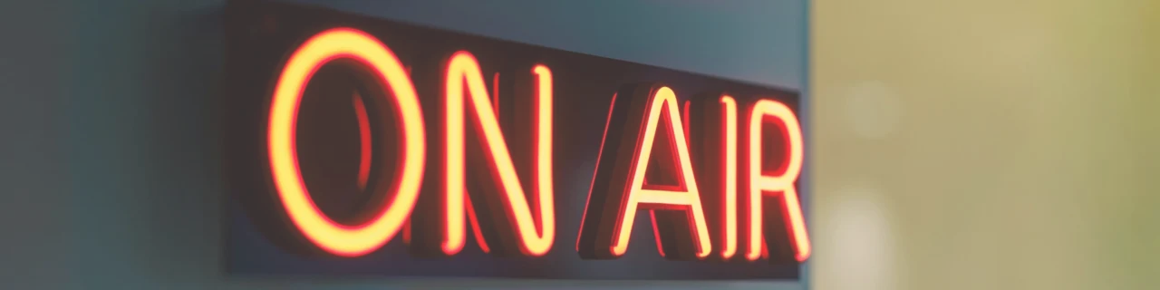 On Air sign glowing inside a Christian prayer radio Denver broadcast studio, symbolizing live faith-based radio programming