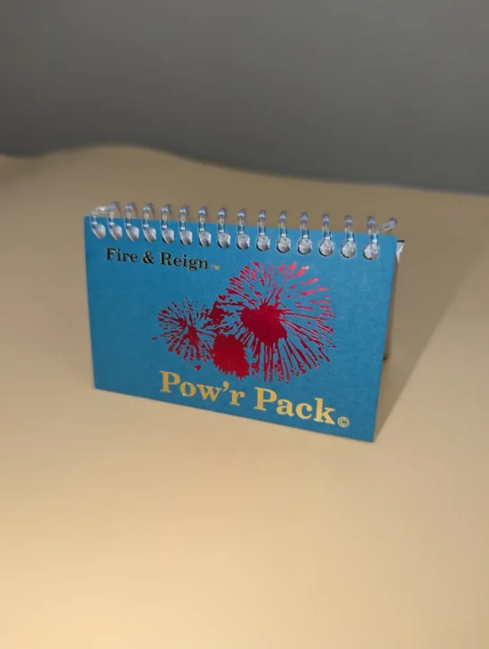 Fire & Reign Pow’r Pack fireworks package with blue cover and red burst design.